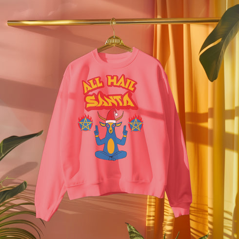 A Christmas sweatshirt featuring a playful design with a cartoon Baphomet goat character wearing a Santa hat. The design includes the text "All Hail Santa" above the goat, with pentagrams in flames on either side. The goat is depicted in a meditative pose, adding a humorous and irreverent twist to holiday attire.
